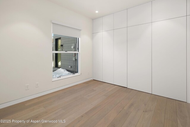 211 W Main St, Aspen, CO 81611 - unfurnished bedroom with light wood-style flooring, recessed lighting, and a closet