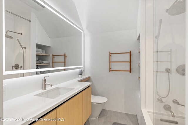 211 W Main St, Aspen, CO 81611 - full bathroom featuring vanity, toilet, vaulted ceiling, and tub / shower combination