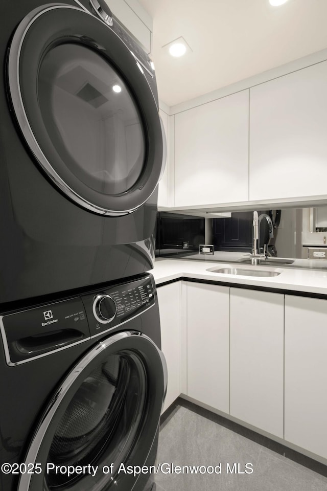 211 W Main St, Aspen, CO 81611 - laundry room featuring stacked washer / dryer, cabinet space, and recessed lighting