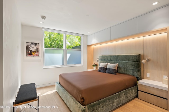 211 W Main St, Aspen, CO 81611 - bedroom with light wood finished floors and recessed lighting