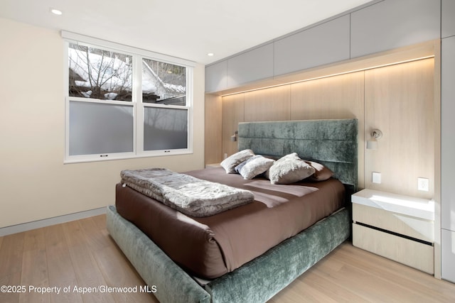 211 W Main St, Aspen, CO 81611 - bedroom with light wood-style floors and recessed lighting