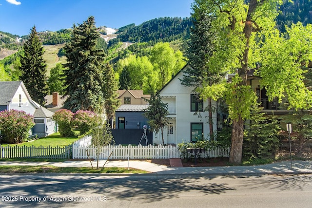 211 W Main St, Aspen, CO 81611 - view of front facade with a fenced front yard and a mountain view
