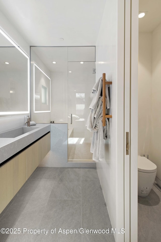 211 W Main St, Aspen, CO 81611 - bathroom with toilet, tile patterned flooring, vanity, and a shower stall
