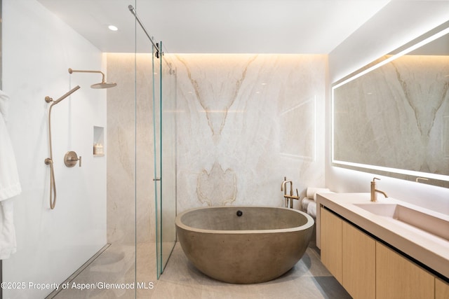 211 W Main St, Aspen, CO 81611 - full bathroom featuring a marble finish shower, vanity, and a soaking tub