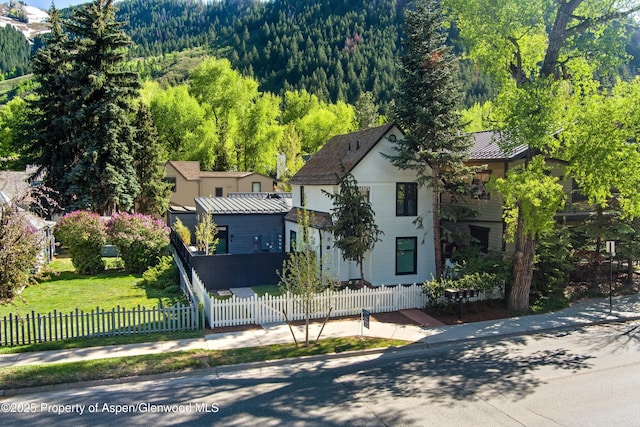 211 W Main St, Aspen, CO 81611 - view of front of home featuring a forest view