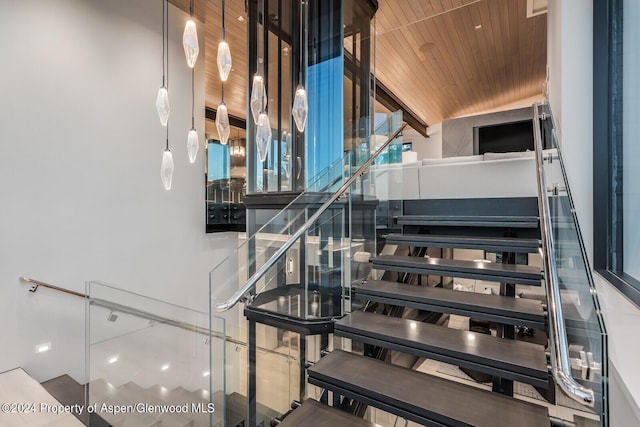 stairway featuring wooden ceiling