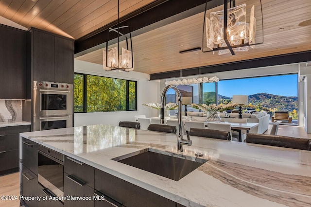 kitchen with wooden ceiling, sink, pendant lighting, and appliances with stainless steel finishes