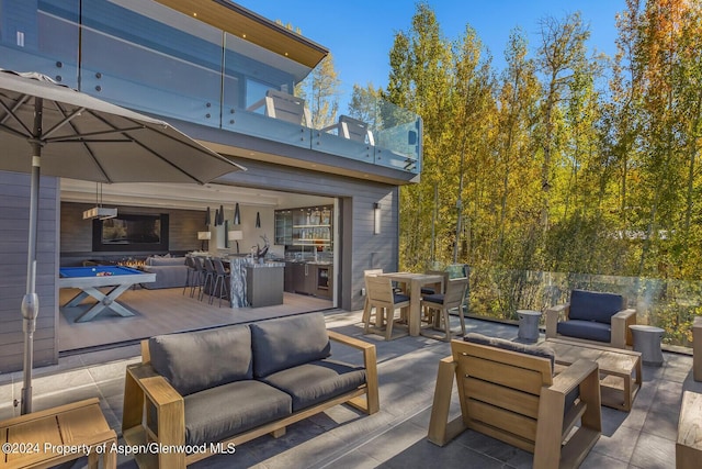 view of patio / terrace featuring an outdoor living space with a fireplace