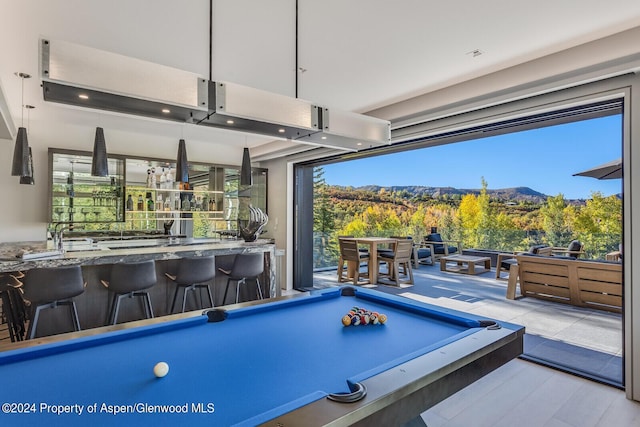 game room featuring a mountain view, bar area, and billiards