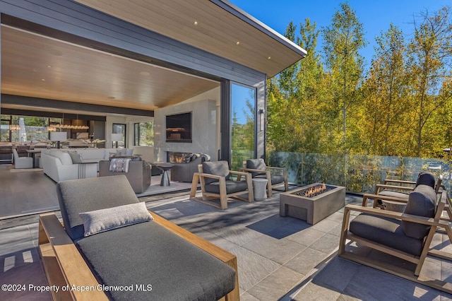 view of patio / terrace featuring an outdoor living space with a fireplace