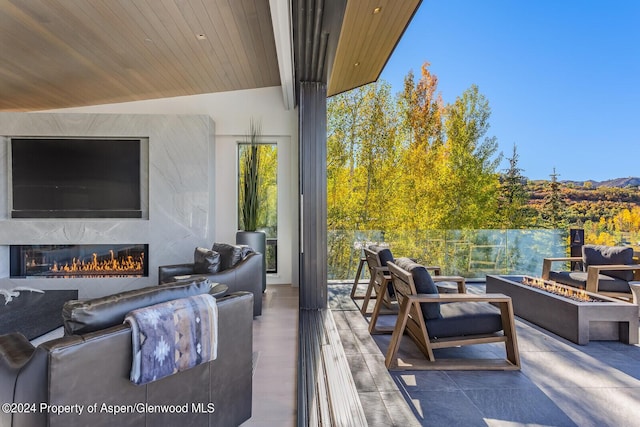 view of patio featuring an outdoor living space with a fireplace