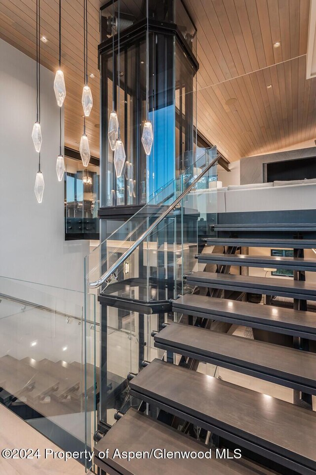 staircase with wooden ceiling