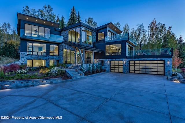 contemporary house featuring a balcony and a garage