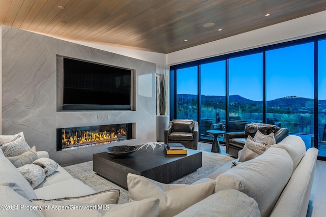 living room with a fireplace and wood ceiling