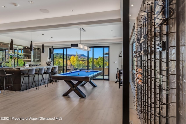 game room featuring a mountain view, indoor bar, hardwood / wood-style flooring, and billiards