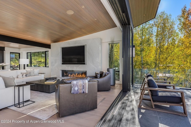 view of patio / terrace with an outdoor living space with a fireplace