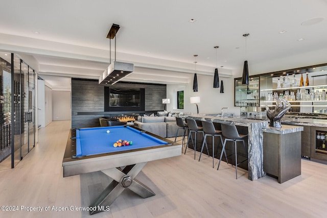 playroom with light hardwood / wood-style floors and pool table