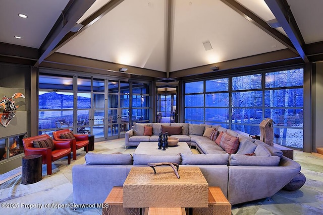 living room with recessed lighting, beam ceiling, and a towering ceiling