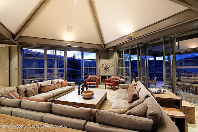 living room with beam ceiling and high vaulted ceiling