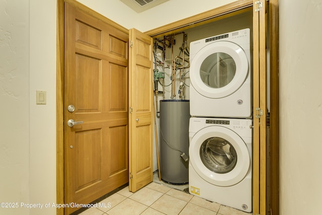201 14th St Unit 300, Glenwood Springs, CO 81601 - laundry area featuring water heater, stacked washing machine and dryer, and light tile patterned floors