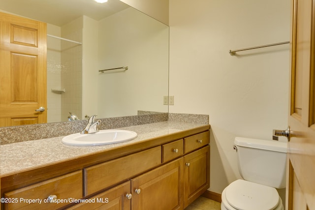 201 14th St Unit 300, Glenwood Springs, CO 81601 - bathroom with vanity, toilet, a shower, and tile patterned floors