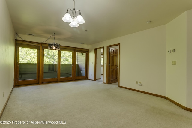 201 14th St Unit 300, Glenwood Springs, CO 81601 - carpeted empty room with a chandelier, baseboards, and a smoke detector