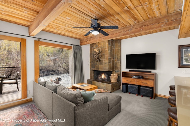 1039 E Cooper Ave Unit 21, Aspen, CO 81611 - carpeted living room with wooden ceiling with exposed beams, a tiled fireplace, a ceiling fan, and baseboards