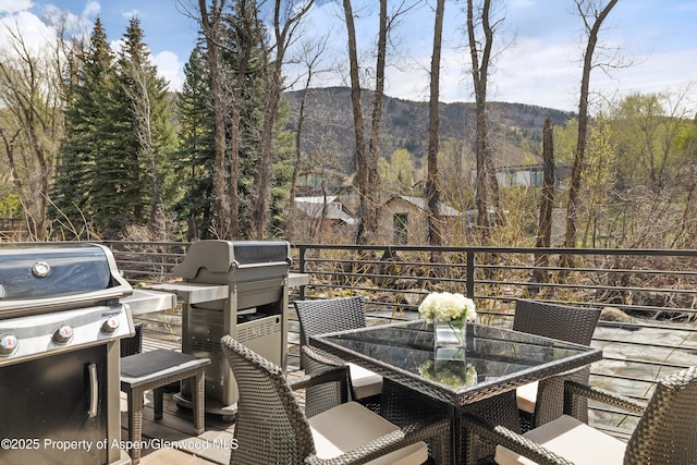 1039 E Cooper Ave Unit 21, Aspen, CO 81611 - deck featuring outdoor dining area, a grill, and a mountain view