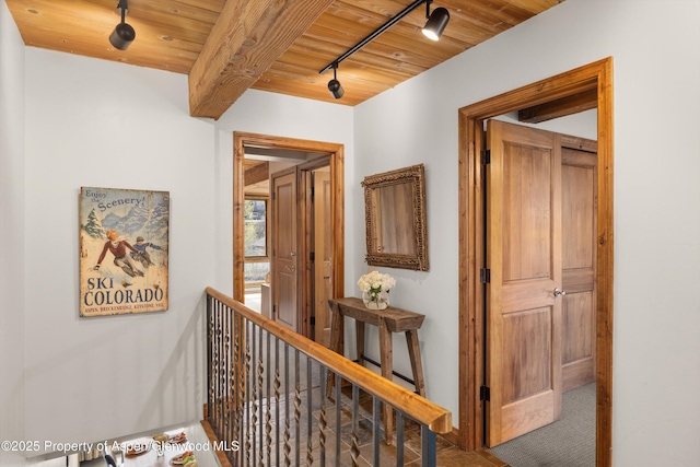 1039 E Cooper Ave Unit 21, Aspen, CO 81611 - hall featuring wood ceiling with exposed beams, an upstairs landing, and rail lighting