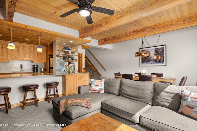 1039 E Cooper Ave Unit 21, Aspen, CO 81611 - living room with wood ceiling with exposed beams, light colored carpet, stairs, and ceiling fan