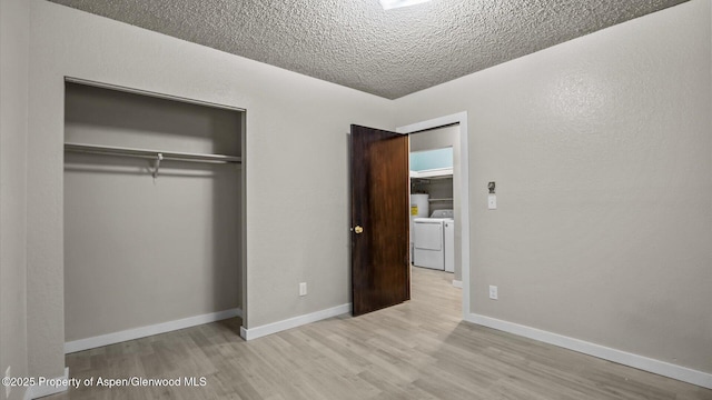 200 S E Ave Unit 111, New Castle, CO 81647 - unfurnished bedroom with washing machine and clothes dryer, wood finished floors, a closet, and a textured ceiling