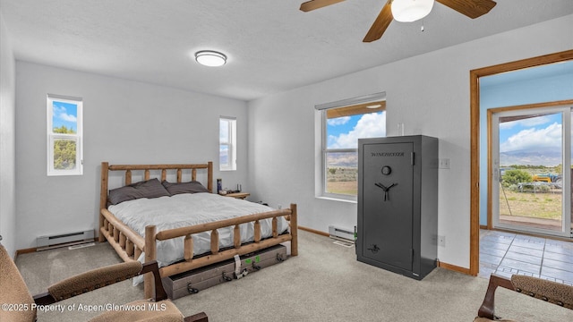 2051 Grass Mesa Rd, Rifle, CO 81650 - carpeted bedroom with baseboard heating, baseboards, a textured ceiling, and a ceiling fan