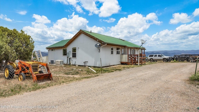 2051 Grass Mesa Rd, Rifle, CO 81650 - view of side of property with metal roof, driveway, central air condition unit, and a mountain view