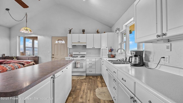 2051 Grass Mesa Rd, Rifle, CO 81650 - kitchen featuring white range with gas cooktop, a sink, under cabinet range hood, white cabinetry, and high vaulted ceiling