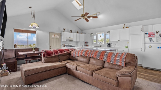 2051 Grass Mesa Rd, Rifle, CO 81650 - living room with high vaulted ceiling, a ceiling fan, and a skylight