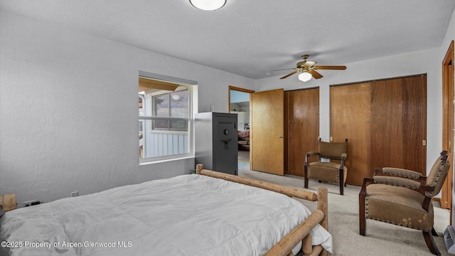 2051 Grass Mesa Rd, Rifle, CO 81650 - bedroom featuring carpet floors, multiple closets, a textured wall, and a ceiling fan