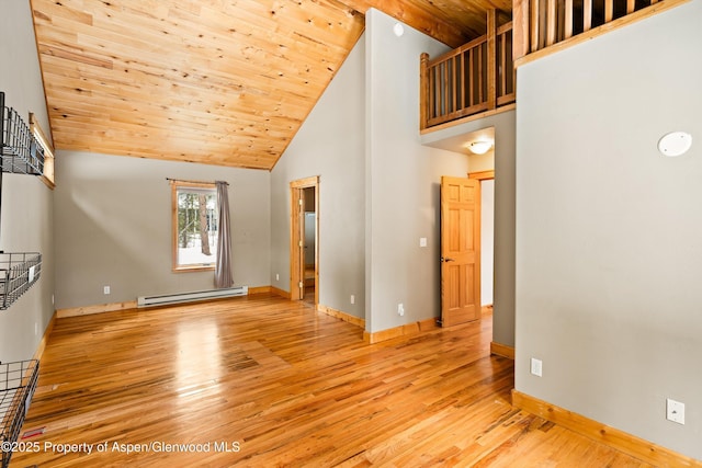 unfurnished living room featuring high vaulted ceiling, light wood-style flooring, baseboard heating, and wood ceiling