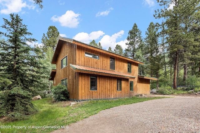 view of side of property featuring metal roof