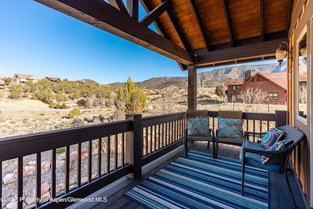 wooden deck with a mountain view