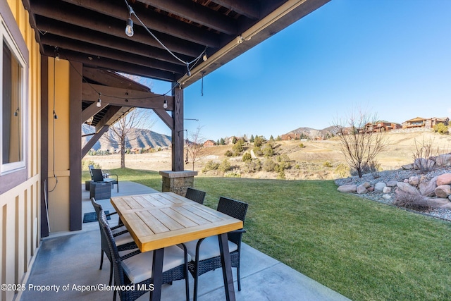 view of patio featuring outdoor dining space and a mountain view