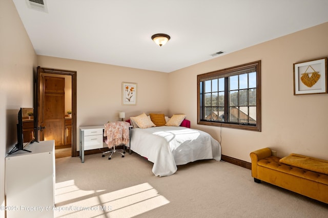 carpeted bedroom featuring visible vents and baseboards