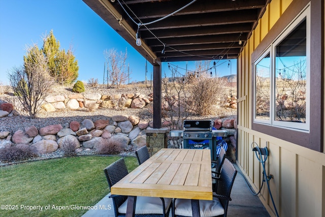 view of patio with area for grilling and outdoor dining area