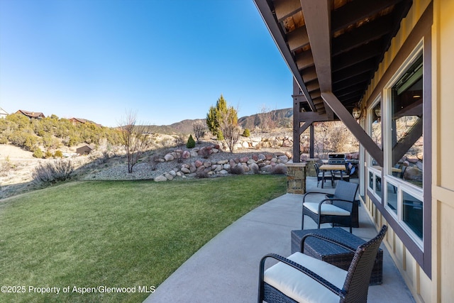 view of yard with a patio and a mountain view