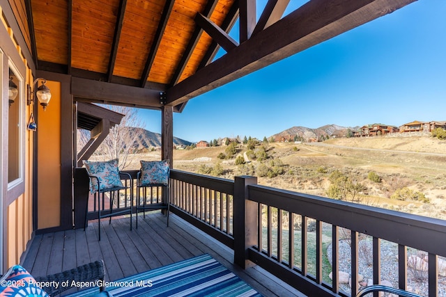 wooden deck featuring a mountain view