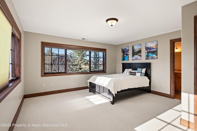 carpeted bedroom featuring visible vents and baseboards