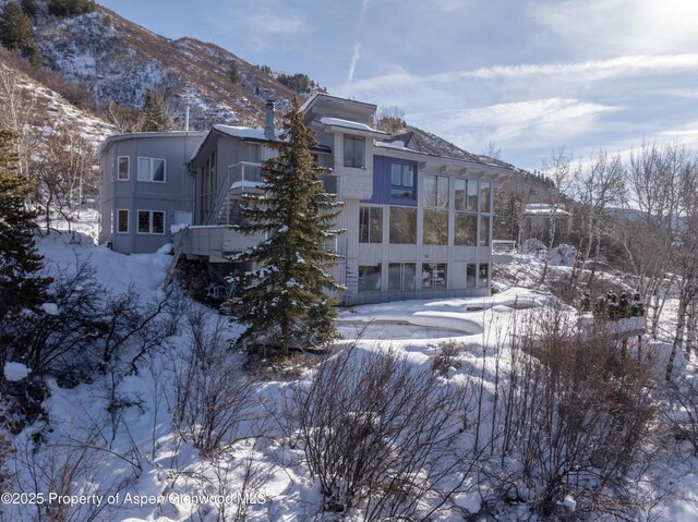 snow covered house with a mountain view