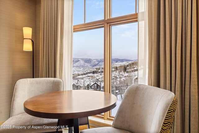 dining area with expansive windows and a mountain view