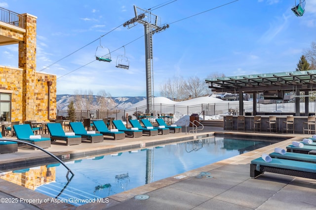 view of swimming pool featuring a mountain view and a patio area