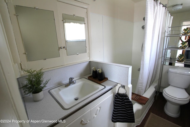 full bathroom featuring shower / bath combination with curtain, vanity, and toilet