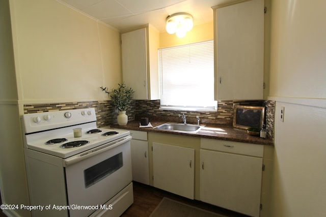 kitchen featuring backsplash, sink, and white electric range oven